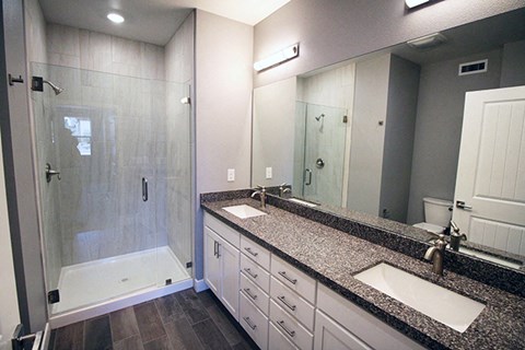 Reno NV Apartments-Park Place Bathroom with Double Sink and Large Shower with Glass Door